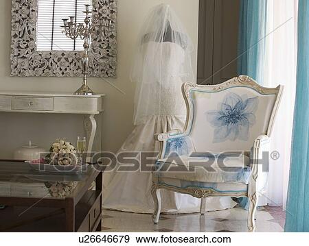 Stock Photo - A wedding dress in a room. Fotosearch