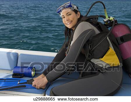 Stock Photography - A woman about to go scuba diving. Fotosearch