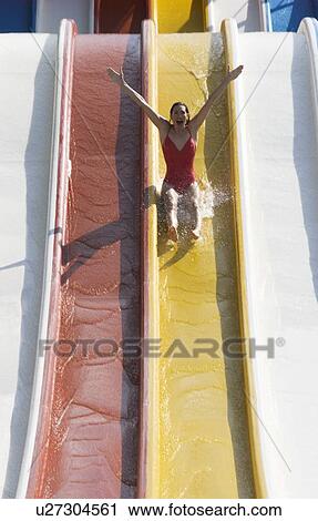 A woman coming down a slide in a waterpark View Large Photo Image Stock Image - A woman coming down a slide in a waterpark. Fotosearch