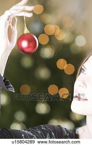 A woman holding a Christmas decoration View Large Photo Image Stock Photo - A woman holding a Christmas decoration. Fotosearch