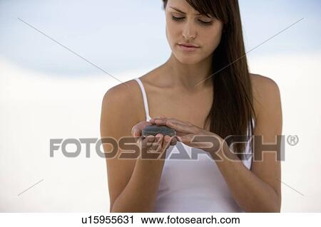 A woman holding a stone View Large Photo Image Stock Image - A woman holding a stone. Fotosearch