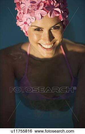 Stock Photograph - A woman in a bikini and swimming hat. Fotosearch