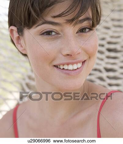 Stock Photograph - A woman relaxing in a hammock. Fotosearch