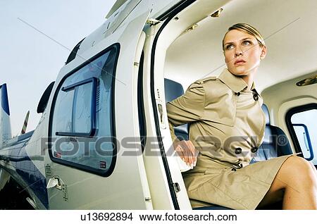Picture - A woman sitting in a helicopter. Fotosearch