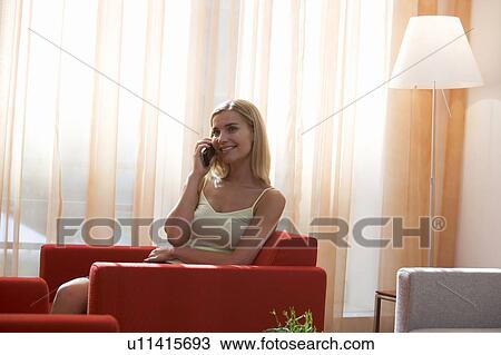 Stock Image - A woman talking on a mobile phone. Fotosearch