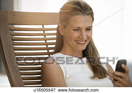 A woman using a mobile phone View Large Photo Image Stock Photo - A woman using a mobile phone. Fotosearch