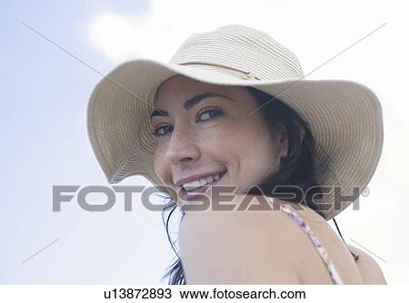 Stock Image - A woman wearing a hat. Fotosearch