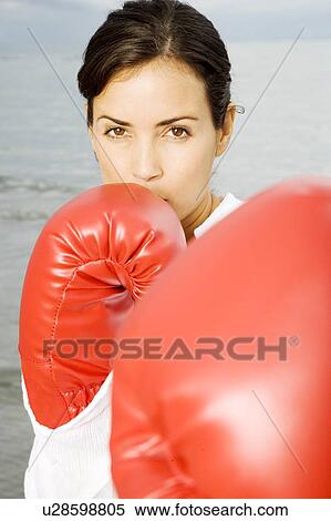 A woman wearing boxing gloves on a beach View Large Photo Image Stock Photography - A woman wearing boxing gloves on a beach. Fotosearch