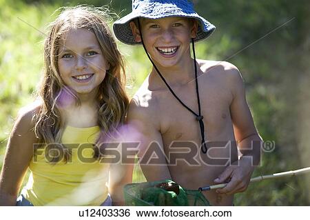 Stock Photograph - A young boy and girl with a fishing net. Fotosearch