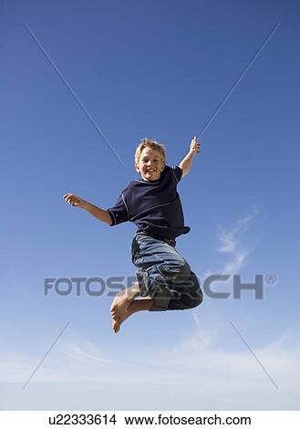 A young boy jumping View Large Photo Image Picture - A young boy jumping. Fotosearch