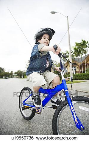 Stock Photograph - A young boy on a bike. Fotosearch