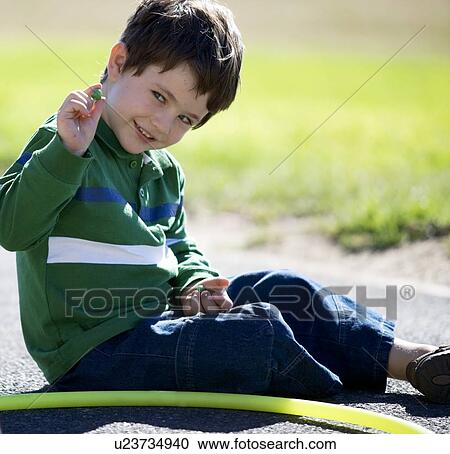 A young boy playing marbles View Large Photo Image Stock Image - A young boy playing marbles. Fotosearch