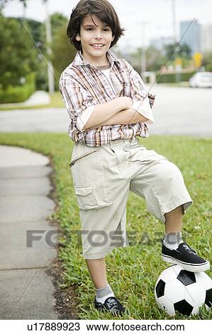 A young boy with a football View Large Photo Image Stock Image - A young boy with a football. Fotosearch