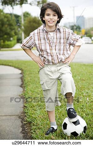 Stock Image - A young boy with a football. Fotosearch
