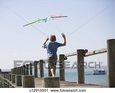 A young boy with a kite View Large Photo Image Stock Image - A young boy with a kite. Fotosearch