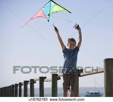 A young boy with a kite View Large Photo Image Stock Image - A young boy with a kite. Fotosearch