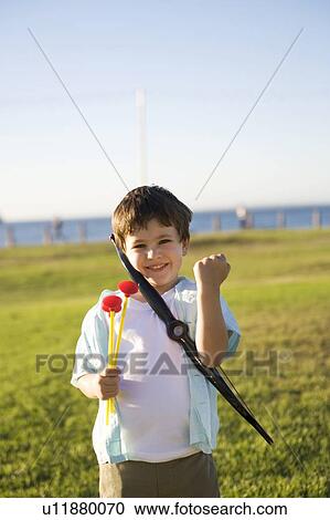 A young boy with a toy bow and arrows View Large Photo Image Stock Image - A young boy with a toy bow and arrows. Fotosearch