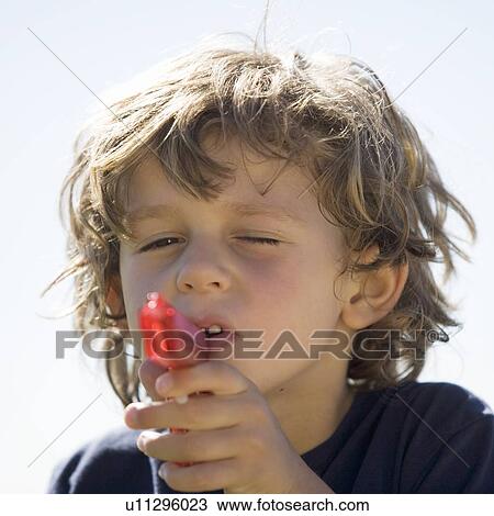 Stock Image - A young boy with a water pistol. Fotosearch
