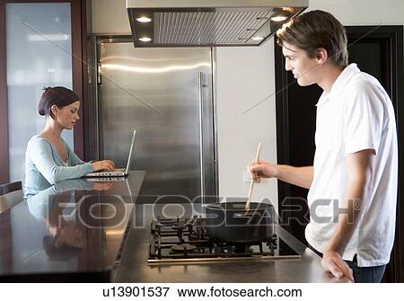 Stock Photo - A young couple at home. Fotosearch