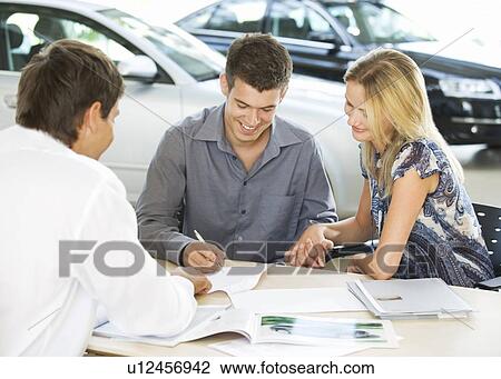 A young couple buying a new car View Large Photo Image Stock Image - A young couple buying a new car. Fotosearch