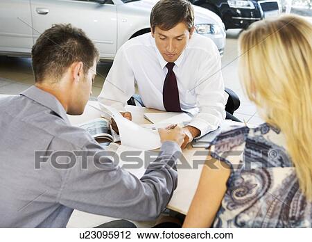 A young couple buying a new car View Large Photo Image Stock Image - A young couple buying a new car. Fotosearch