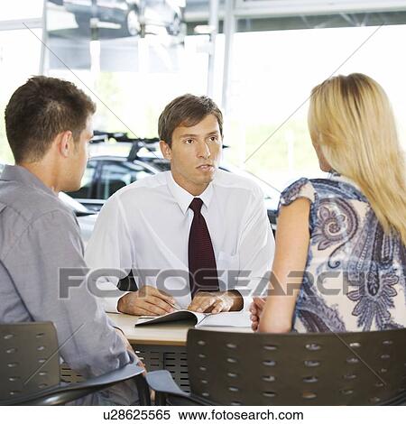 A young couple buying a new car View Large Photo Image Stock Photography - A young couple buying a new car. Fotosearch