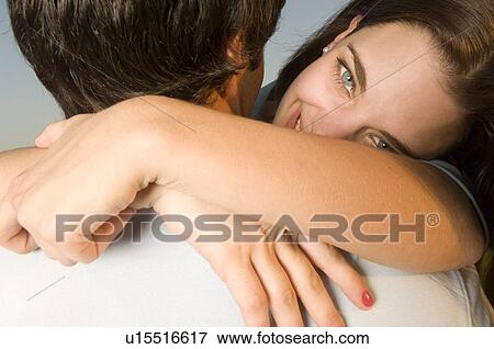 A young couple embracing View Large Photo Image Stock Photo - A young couple embracing. Fotosearch