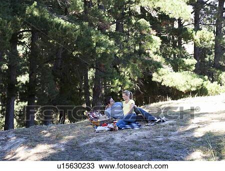 Stock Image - A young couple having a picnic. Fotosearch