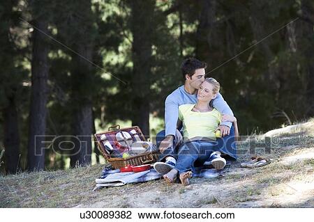 Stock Image - A young couple having a picnic. Fotosearch