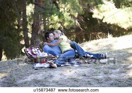 Stock Photo - A young couple having a picnic. Fotosearch