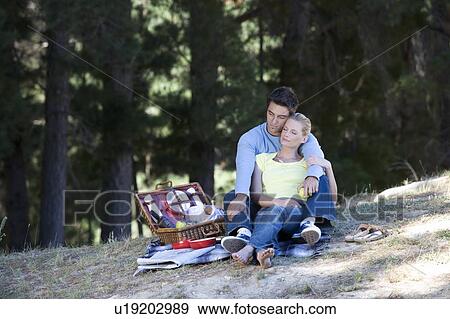 Stock Photo - A young couple having a picnic. Fotosearch