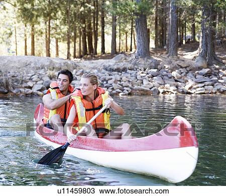 Stock Image - A young couple in a canoe. Fotosearch
