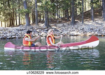 A young couple in a canoe View Large Photo Image Stock Photo - A young couple in a canoe. Fotosearch