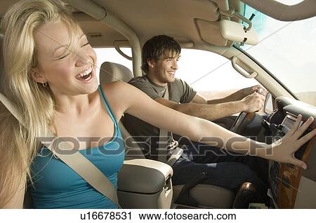 Stock Image - A young couple in a car. Fotosearch
