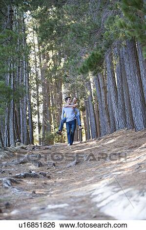 A young couple in a forest View Large Photo Image Stock Photograph - A young couple in a forest. Fotosearch