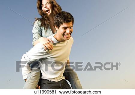 A young couple in a park View Large Photo Image Stock Image - A young couple in a park. Fotosearch