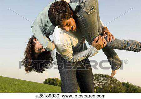 A young couple in a park View Large Photo Image Stock Image - A young couple in a park. Fotosearch