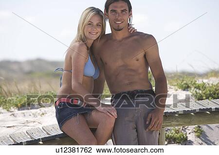 Stock Image - A young couple on a beach. Fotosearch