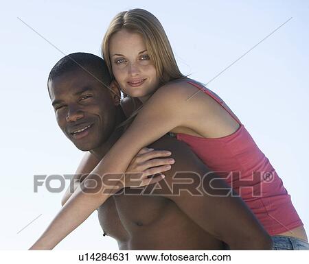 A young couple on a beach View Large Photo Image Stock Image - A young couple on a beach. Fotosearch