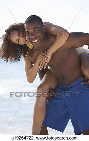 Stock Image - A young couple on a beach. Fotosearch