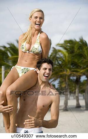 A young couple on a beach View Large Photo Image Stock Photo - A young couple on a beach. Fotosearch