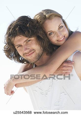Stock Photo - A young couple on a beach. Fotosearch