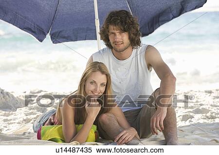 A young couple on a beach View Large Photo Image Stock Photography - A young couple on a beach. Fotosearch