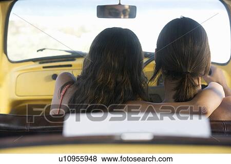 Stock Photo - A young couple sitting in a car. Fotosearch