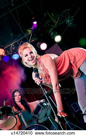 Stock Image - A young female singer performing. Fotosearch