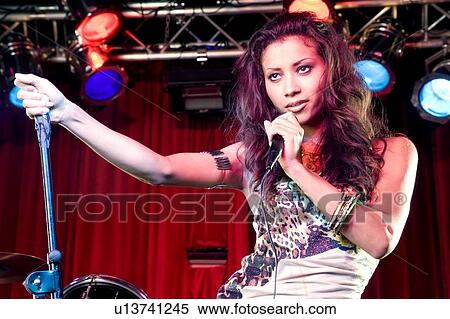 Stock Photography - A young female singer performing. Fotosearch
