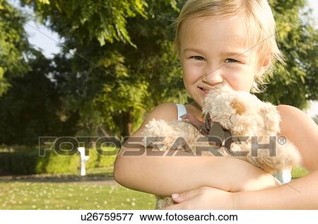 A young girl holding a teddy bear View Large Photo Image Stock Photo - A young girl holding a teddy bear. Fotosearch