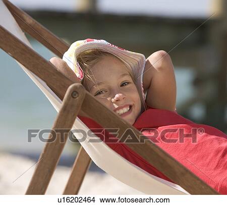 Picture - A young girl in a deck chair. Fotosearch