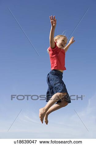A young girl jumping View Large Photo Image Stock Photo - A young girl jumping. Fotosearch