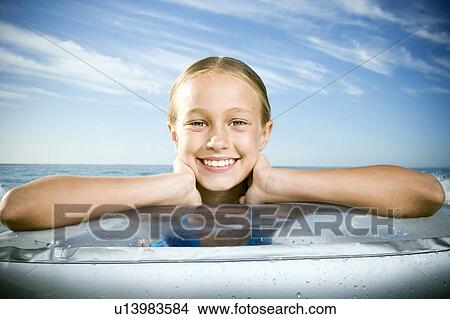 A young girl laying on a lilo View Large Photo Image Picture - A young girl laying on a lilo. Fotosearch
